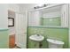 Bathroom with pedestal sink and shower at 10308 Forest Hills Dr, Tampa, FL 33612