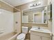 Second bathroom with beige tile and shower/tub combo at 10308 Forest Hills Dr, Tampa, FL 33612