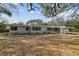 Ranch-style home with carport and large yard at 10308 Forest Hills Dr, Tampa, FL 33612