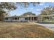 Exterior view of a single story house with carport and lawn at 10308 Forest Hills Dr, Tampa, FL 33612