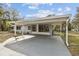 Front view of a gray house with carport at 10308 Forest Hills Dr, Tampa, FL 33612