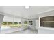 Front porch with screened enclosure, view of yard at 10308 Forest Hills Dr, Tampa, FL 33612