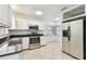 Kitchen with white cabinets and stainless steel appliances at 10308 Forest Hills Dr, Tampa, FL 33612