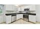 Kitchen with white cabinets, granite counters, and stainless steel appliances at 10308 Forest Hills Dr, Tampa, FL 33612