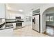 Kitchen with white cabinets and stainless steel appliances at 10308 Forest Hills Dr, Tampa, FL 33612
