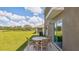 Relaxing patio with table and chairs, overlooking grassy backyard at 10828 Hidden Banks Gln, Parrish, FL 34219