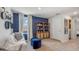 Upstairs loft area with blue accent wall, comfy seating, and built-in shelving at 10828 Hidden Banks Gln, Parrish, FL 34219