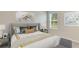 Bedroom with a gray headboard and yellow and gray bedding at 10873 Gentle Current Way, Parrish, FL 34219