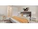 Spacious bedroom with a gray headboard and orange bedding at 10873 Gentle Current Way, Parrish, FL 34219