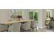 Bright dining area with a wooden table and six chairs at 10873 Gentle Current Way, Parrish, FL 34219