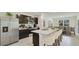 Modern kitchen with stainless steel appliances and an island at 10873 Gentle Current Way, Parrish, FL 34219