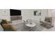 Living room features a neutral color palette, comfy seating, and a large TV at 10873 Gentle Current Way, Parrish, FL 34219