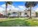Ranch style home with a large yard and palm trees at 1145 Boca Ciega Isle Dr, St Pete Beach, FL 33706