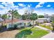 Cute yellow house with teal accents and palm trees at 1145 Boca Ciega Isle Dr, St Pete Beach, FL 33706