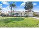 Ranch style home with a large yard and palm trees at 1145 Boca Ciega Isle Dr, St Pete Beach, FL 33706