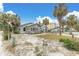 Quaint beach cottage with a sandy front yard at 130 90Th Ave, Treasure Island, FL 33706