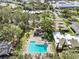 Aerial view showing community pool and surrounding buildings at 1581 Amberlea S Dr, Dunedin, FL 34698