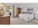 Spacious bedroom with large window, neutral decor, and wood dresser at 1581 Amberlea S Dr, Dunedin, FL 34698