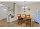 Bright dining area with wood table and chairs, light flooring, and blue dresser at 1581 Amberlea S Dr, Dunedin, FL 34698