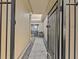 Private gated entry to condo with a stone path at 1581 Amberlea S Dr, Dunedin, FL 34698