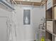 Storage closet with shelving, water heater, and electrical panel at 1581 Amberlea S Dr, Dunedin, FL 34698