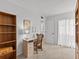 Home office with built-in shelving and a view of the bathroom at 1581 Amberlea S Dr, Dunedin, FL 34698