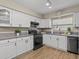 Well-equipped kitchen with white cabinets and modern appliances at 1581 Amberlea S Dr, Dunedin, FL 34698