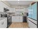 Well-equipped kitchen with white cabinets and modern appliances at 1581 Amberlea S Dr, Dunedin, FL 34698