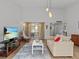 Bright living room with hardwood floors and large windows at 1581 Amberlea S Dr, Dunedin, FL 34698