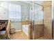 Spa-like bathroom with a soaking tub and walk-in shower at 15811 Oakleaf Run Dr, Lithia, FL 33547