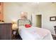 Bedroom with a full-size bed and an adjacent room at 15811 Oakleaf Run Dr, Lithia, FL 33547