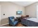Bedroom featuring a double bed, armchair, and mounted TV at 15811 Oakleaf Run Dr, Lithia, FL 33547