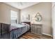 Simple bedroom with a twin bed, nightstand, and wall art at 15811 Oakleaf Run Dr, Lithia, FL 33547