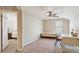 Bedroom with a twin bed, desk, and view into another bedroom at 15811 Oakleaf Run Dr, Lithia, FL 33547