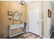 Entryway with console table, mirror, and decorative wall art at 15811 Oakleaf Run Dr, Lithia, FL 33547