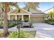 House exterior featuring a two-car garage and a manicured lawn at 15811 Oakleaf Run Dr, Lithia, FL 33547