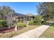Rear house view, showcasing the screened patio and landscaping at 15811 Oakleaf Run Dr, Lithia, FL 33547