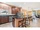 Modern kitchen with granite countertops, stainless steel appliances, and an island at 15811 Oakleaf Run Dr, Lithia, FL 33547