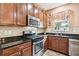 Well-equipped kitchen boasts dark wood cabinets and granite countertops at 15811 Oakleaf Run Dr, Lithia, FL 33547