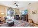 Cozy living room featuring a fireplace, comfortable seating, and sliding glass doors leading to a patio at 15811 Oakleaf Run Dr, Lithia, FL 33547