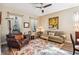 Living room with comfortable seating, area rug, and large windows at 15811 Oakleaf Run Dr, Lithia, FL 33547