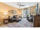 Relaxing living room with leather furniture and sliding glass doors at 15811 Oakleaf Run Dr, Lithia, FL 33547