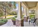 Front porch with seating area overlooking the street at 15811 Oakleaf Run Dr, Lithia, FL 33547