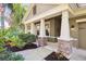 Inviting front porch with stone columns and lush landscaping at 15811 Oakleaf Run Dr, Lithia, FL 33547