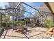 Relaxing screened patio with seating area, water feature, and pergola at 15811 Oakleaf Run Dr, Lithia, FL 33547