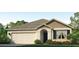 Single-story house with beige siding, gray roof, and a two-car garage at 17217 Wheatberry Blvd, Parrish, FL 34219