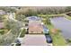 Aerial view showcasing homes near a lake and surrounding landscape at 19820 Morden Blush Dr, Lutz, FL 33558