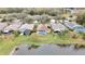 Aerial view of houses near a lake, some with pools and solar panels at 19820 Morden Blush Dr, Lutz, FL 33558