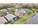 Aerial view of a neighborhood with houses and a pond at 19820 Morden Blush Dr, Lutz, FL 33558