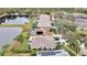 Aerial view of homes near a lake, showcasing solar panels and pools at 19820 Morden Blush Dr, Lutz, FL 33558